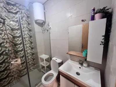 a bathroom with a shower and a toilet and a sink at Nice Apartment near airport mohammed V International Casablanca in Deroua