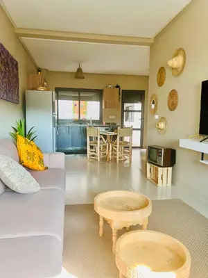 a living room with a couch and a table at Nice Apartment near airport mohammed V International Casablanca in Deroua