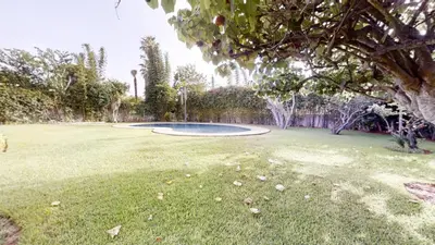 a large yard with a frisbee in the grass at Villa 44- Superbe Villa Moderne 7 chambres, 2500m2, piscine, cinema, clim , meublee in Rabat