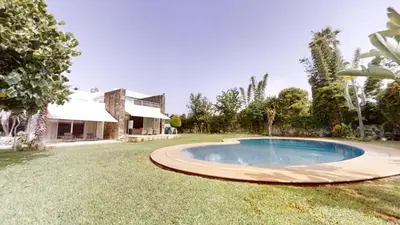 a swimming pool in the yard of a house at Villa 44- Superbe Villa Moderne 7 chambres, 2500m2, piscine, cinema, clim , meublee in Rabat