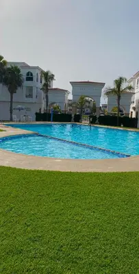a large swimming pool in front of a building at harhoura Résidence Badia in Temara