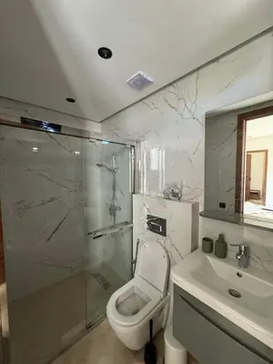 a bathroom with a shower and a toilet and a sink at Casablanca Maarif Extension Green Retreat in Casablanca