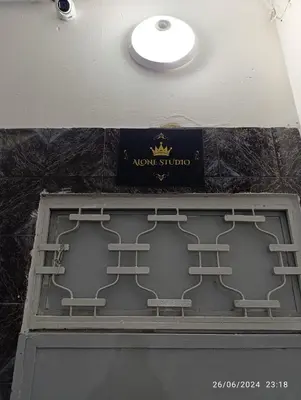 a sign on top of a door with three benches at Alone Studio in Casablanca