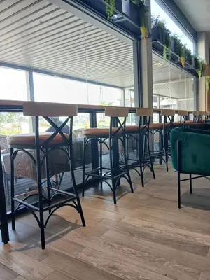 a row of tables and chairs in a restaurant at Ocean Park Zenata City Eco in Casablanca