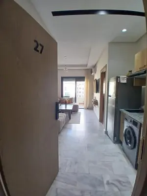 a room with a kitchen and a living room at Ocean Park Zenata City Eco in Casablanca