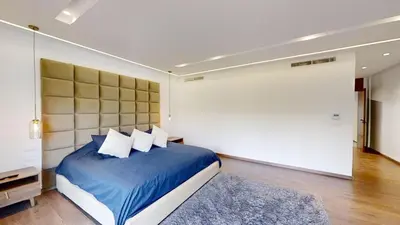 a bedroom with a blue bed with a large headboard at Villa S- Luxurious 8 masterbedrooms villa on 3000m2, close to all amenities, Golf and heart of Souissi in Rabat