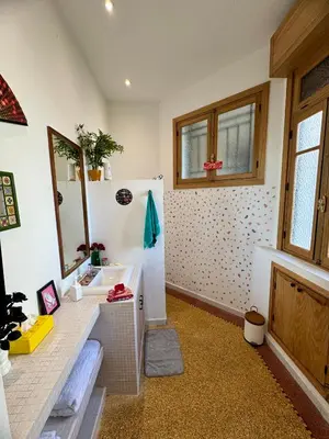 a bathroom with a sink and a refrigerator at Loft art-déco centre-ville Casa in Casablanca