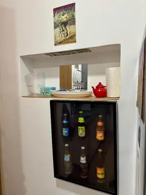 a refrigerator filled with lots of bottles of beer at Loft art-déco centre-ville Casa in Casablanca