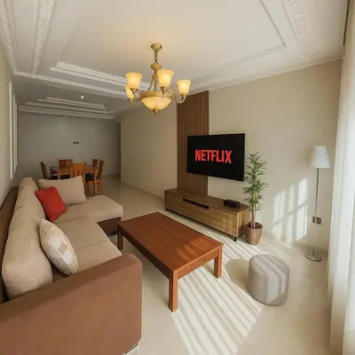 a living room with a couch and a tv at Cosy ensoleillé 3 CH - central et proche du train et tramway in Casablanca