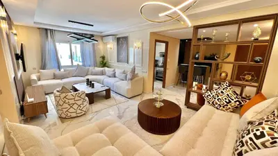 a living room with a couch and a table at N30 Élégance et Confort à La Corniche Rabat - Appartement de Luxe Essabah in Rabat