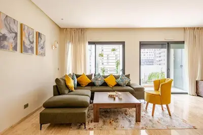 a living room with a couch and a table at Sojori CFC fibre et parking in Casablanca