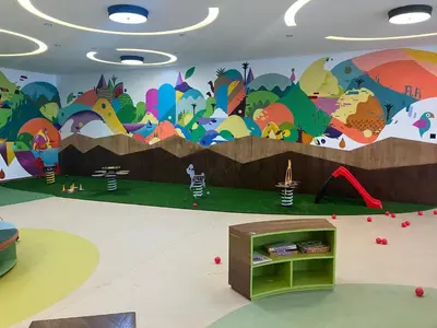 a mural on the wall of a play room with a playground at Moroccan Beach Delight in Dar Bouazza