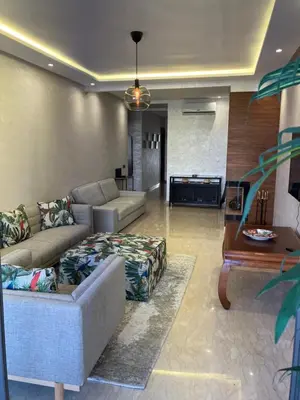 a living room with a couch and a table at Moroccan Beach Delight in Dar Bouazza