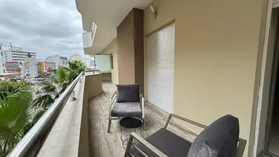 a balcony with a couch and a chair on a building at Street view 2BR Terrace - AppartAli Luxury Platform in Casablanca