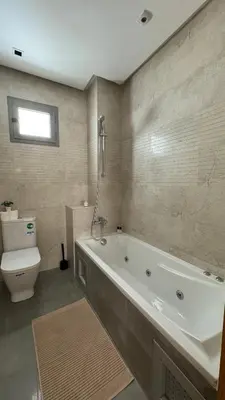 a bathroom with a bath tub and a toilet at Street view 2BR Terrace - AppartAli Luxury Platform in Casablanca