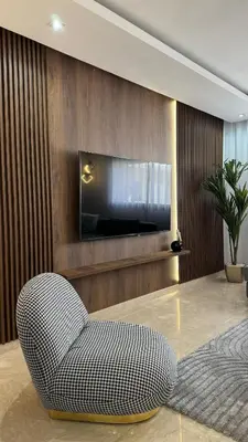 a living room with a chair and a tv at Dreamy 3BR with Terrace -AppartAli Luxury Platform in Casablanca