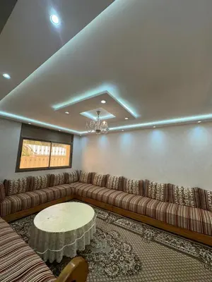 a living room with a couch and a table at Villa à Harhoura in Temara