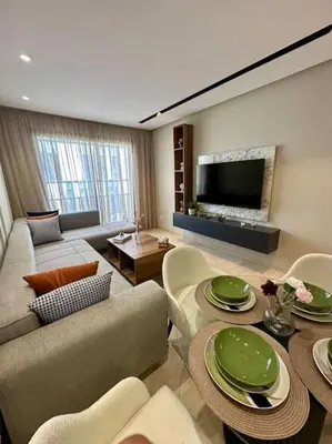 a living room with a couch and a table at Studio Lilas CFC in Casablanca