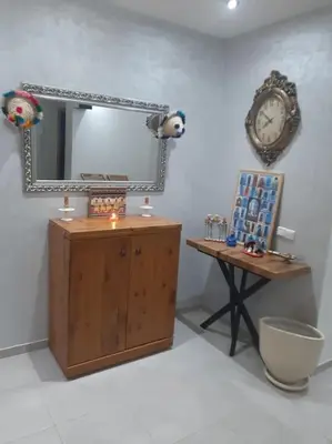 a mirror and a table in a room at Espace de détente in Bouznika