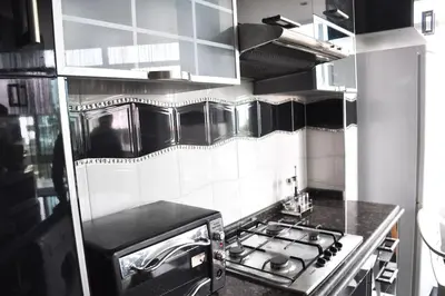 a kitchen with a stove top oven in a kitchen at Appartement a louer Harhoura in Temara