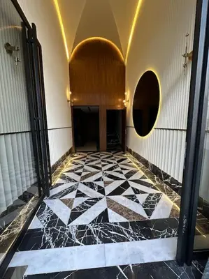 a hallway with a black and white tiled floor at Studio Eucalyptus CFC n 16 in Casablanca