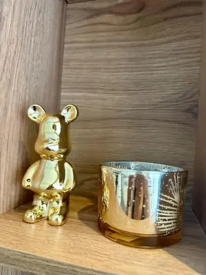 a gold bear figurine next to a cup on a shelf at Studio Eucalyptus CFC n 16 in Casablanca