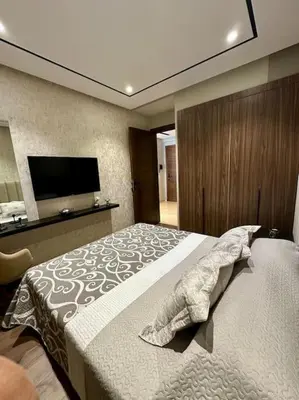 a bedroom with a bed and a flat screen tv at Studio lotus CFC n 21 in Casablanca