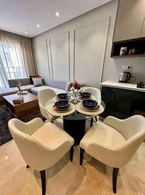 a living room with a table and chairs at Studio lotus CFC n 21 in Casablanca