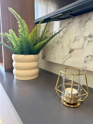 a plant in a vase on a counter with a candle at Studio Vénus CFC n 22 in Casablanca