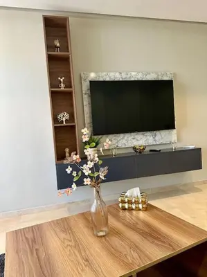 a living room with a vase of flowers on a table at Studio Vénus CFC n 22 in Casablanca