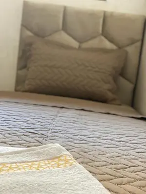 a close up of a bed with a white mattress at Bel appartement de plage - RDC - Dahomey Beach in Bouznika