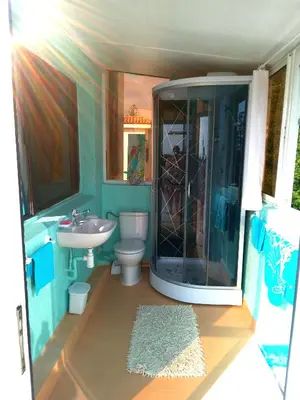 a bathroom with a shower and a toilet and a sink at Skhirat terrace apartment at the beach in Skhirat