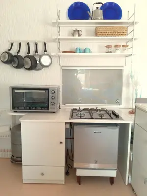 a kitchen with a stove and a microwave at Skhirat terrace apartment at the beach in Skhirat