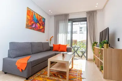 a living room with a couch and a table at Welcome Home Palmiers in Casablanca