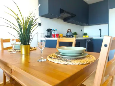 a wooden table with a bowl and glasses on it at Welcome Home Palmiers in Casablanca