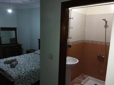 a bathroom with a bed and a sink and a shower at Appartement à louer UNIQUEMENT pour famille et couple marié in Mohammedia