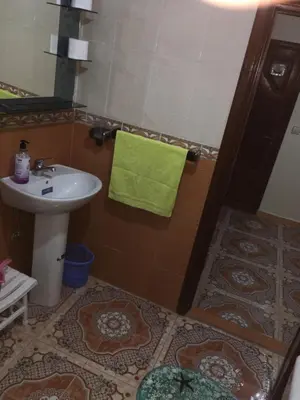 a bathroom with a sink and a green towel at Appartement à louer UNIQUEMENT pour famille et couple marié in Mohammedia