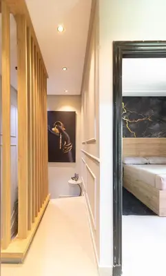 a hallway leading to a bedroom with a bed at L Évasion ZEN Duplex d Exception Entre Plage et Serenite in Mohammedia