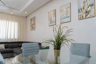a living room with a glass table with a potted plant at Welcome to Casa Luxe 3 King Beds Near CFC & Tram in Casablanca