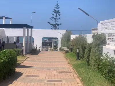a brick walkway next to a building with a bus at Appartement en bord de mer dans une résidence fermée in Casablanca
