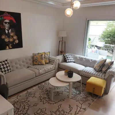 a living room with a couch and a table at Havre de paix à TAMARIS in Dar Mohammed Ould Haj Jilali