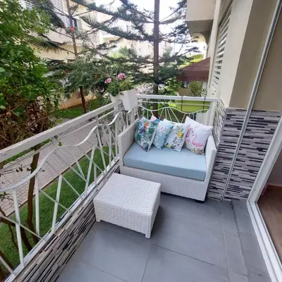 a balcony with a chair with pillows on it at Havre de paix à TAMARIS in Dar Mohammed Ould Haj Jilali