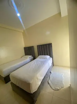 a bedroom with two beds in a room at Well-equipped luxury apartment in Temara