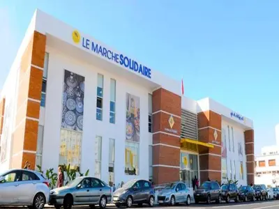 a large building with cars parked in front of it at Cosy and sunny - private Rooftop - near train & tramway in Casablanca