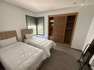 a bedroom with two beds and a closet at Rock Island Appartement Haut standing pied dans l'eau Mohammedia in Mohammedia