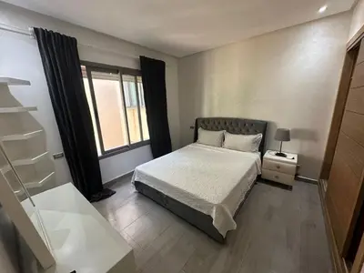 a small bedroom with a bed and a window at Rock Island Appartement Haut standing pied dans l'eau Mohammedia in Mohammedia