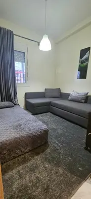 a living room with a bed and a couch at Quiet and Cozy Apartment in Casablanca