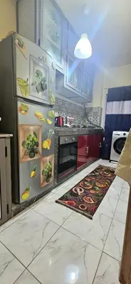a kitchen with a refrigerator with pictures on it at Quiet and Cozy Apartment in Casablanca