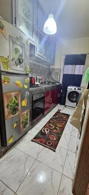 a kitchen with a refrigerator and a counter top at Quiet and Cozy Apartment in Casablanca