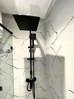 a shower with a light on the wall at Q11 Studio au Cœur de Casablanca Proximité et Confort in Casablanca